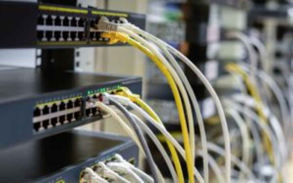 Close-up view of Cisco network switches with connected Ethernet cables, showcasing professional infrastructure